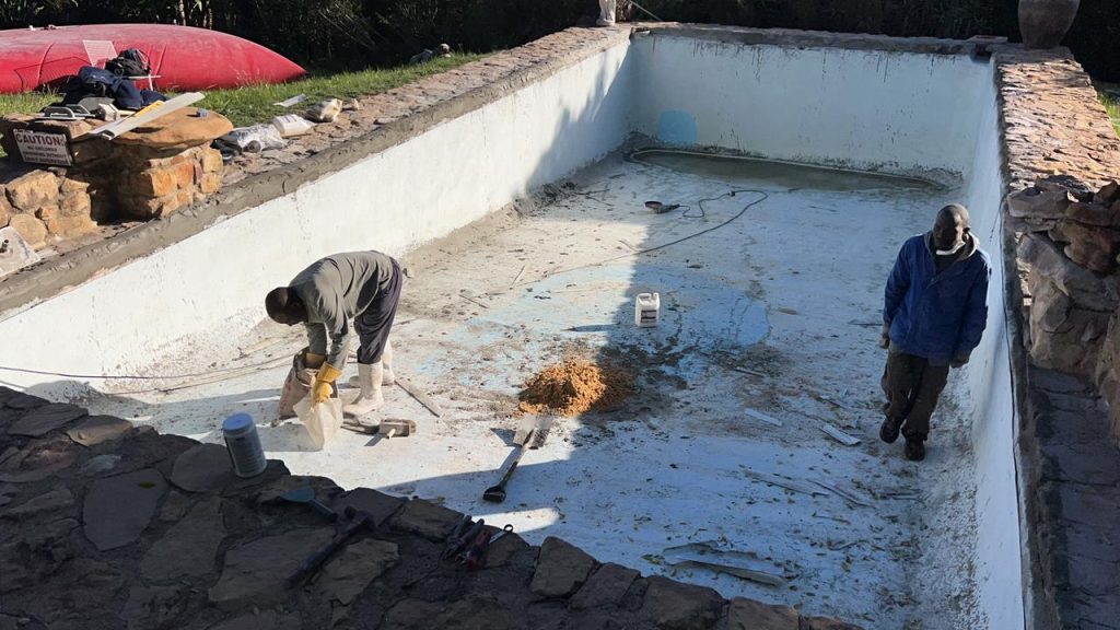 Crack repairs and surface preparation during a pool renovation