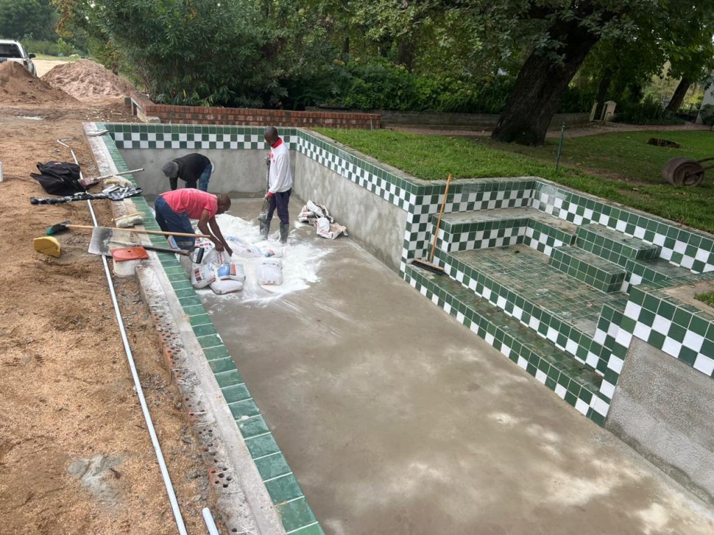 Mosaic waterline tiles on a renovated pool