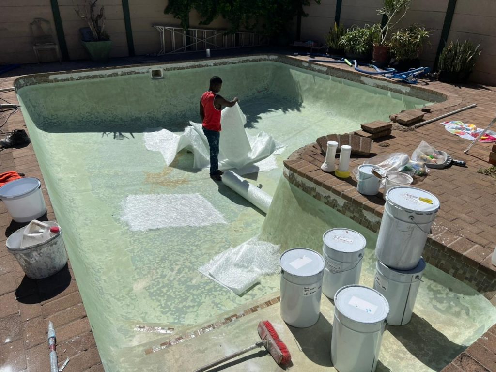 Worn, stained pool surface before renovation