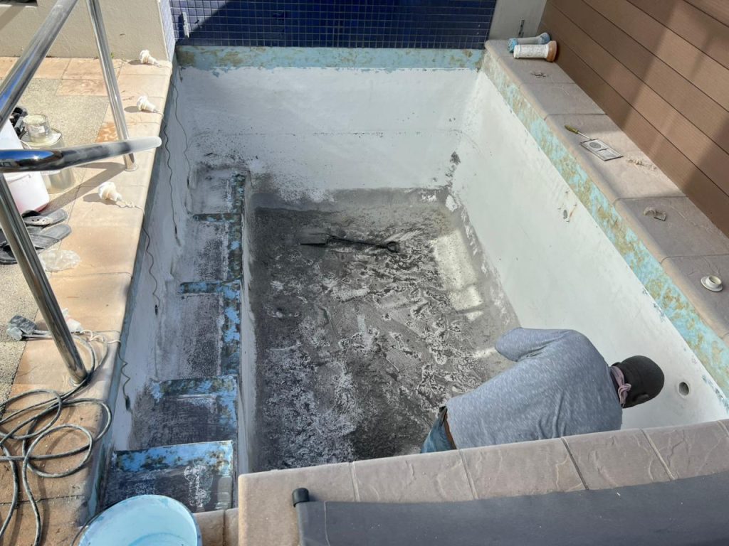 Old pool with a rough, discoloured finish before resurfacing