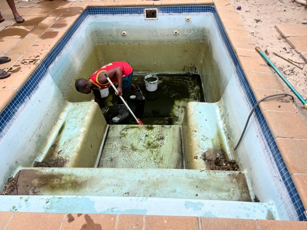 Old pool with a rough, discoloured finish before resurfacing