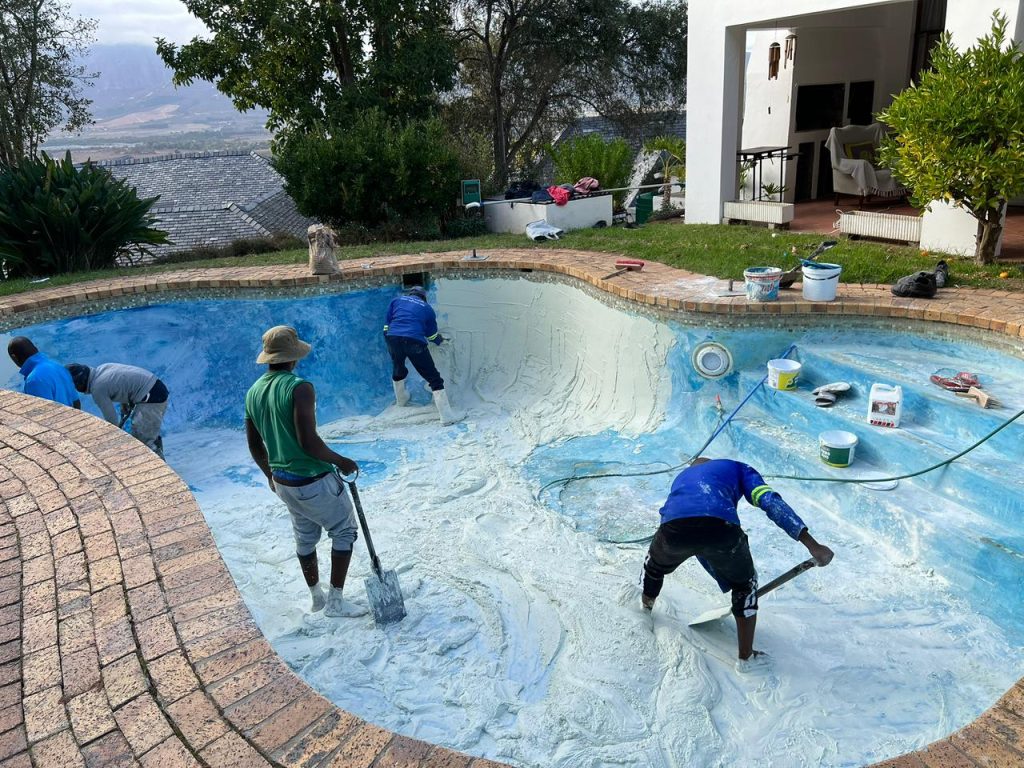 Crack repairs and surface preparation during a pool renovation