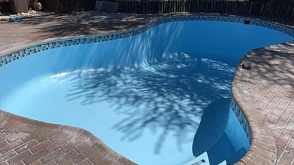 Finished pool renovation with a smooth blue interior