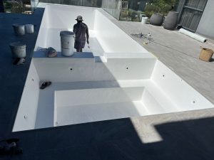 Newly lined swimming pool with a wide entry step being finished by the Aquatic Pools team