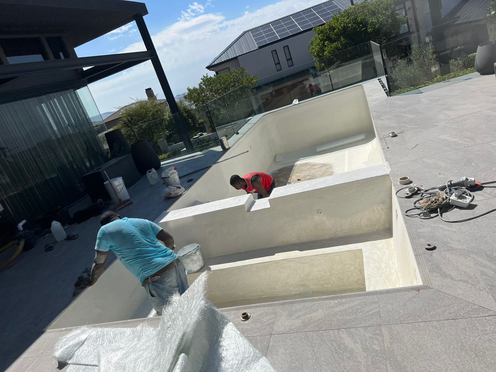 Newly relined swimming pool with steps being finished at a Cape Town home