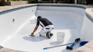 Worker repairing and resurfacing a swimming pool in Cape Town
